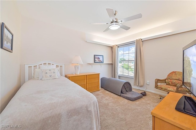 bedroom featuring ceiling fan, baseboards, and light colored carpet