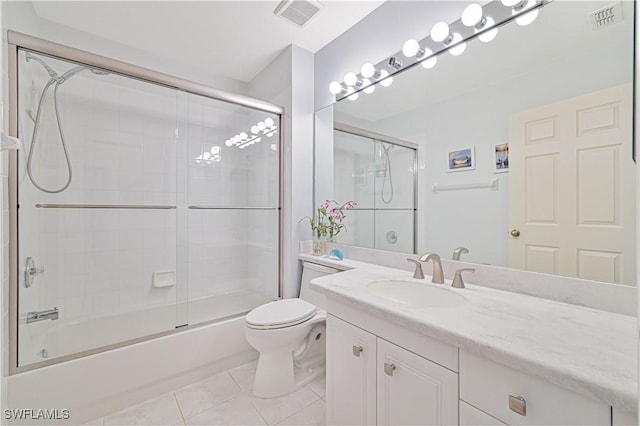 full bath with bath / shower combo with glass door, visible vents, toilet, vanity, and tile patterned flooring