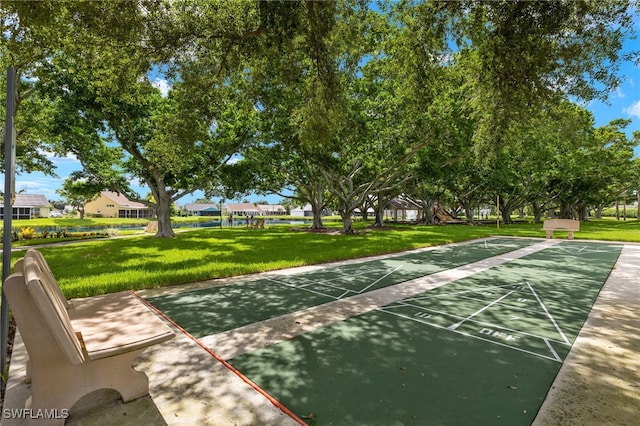 surrounding community featuring a lawn and shuffleboard