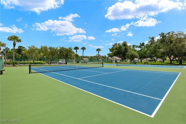 view of tennis court with fence