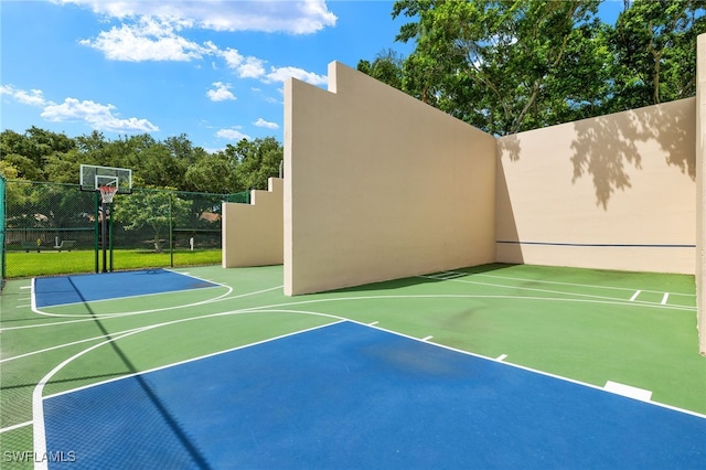 view of basketball court with community basketball court and fence