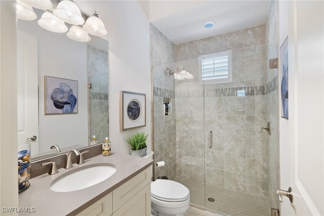 full bath featuring toilet, a shower stall, and vanity