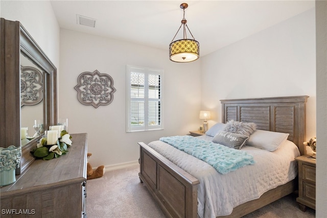 bedroom with baseboards, visible vents, and carpet flooring