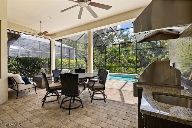 sunroom / solarium featuring ceiling fan and a wealth of natural light