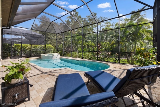 view of pool featuring a patio, a lanai, and a pool with connected hot tub