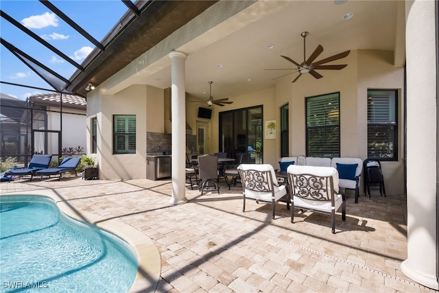 view of patio / terrace with glass enclosure, outdoor dining area, outdoor lounge area, a ceiling fan, and an outdoor pool