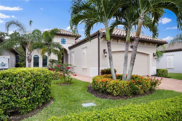 view of property exterior with decorative driveway, a yard, stucco siding, an attached garage, and a tiled roof