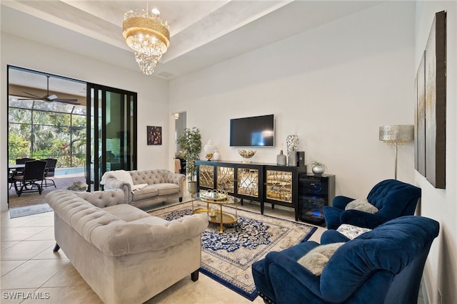 tiled living room with a raised ceiling and an inviting chandelier