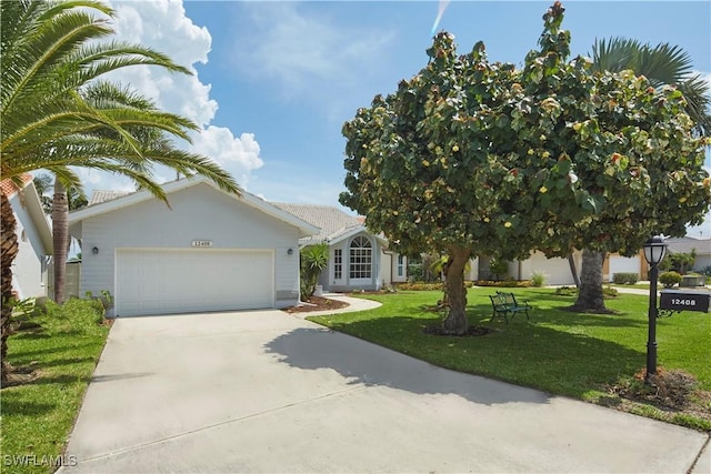 view of front facade featuring an attached garage, a front lawn, concrete driveway, and stucco siding