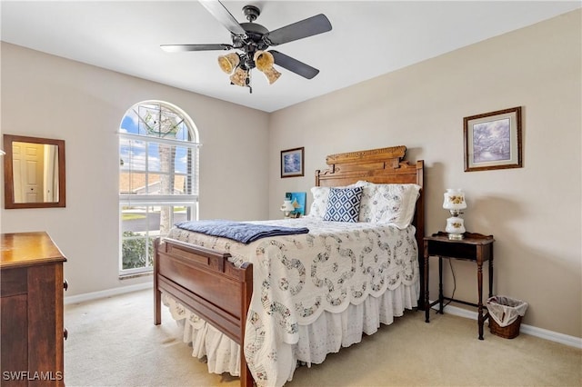 bedroom featuring ceiling fan, baseboards, and light colored carpet