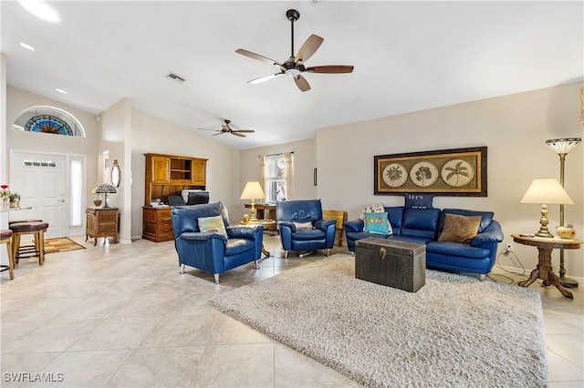 living area featuring lofted ceiling, ceiling fan, visible vents, and light tile patterned flooring