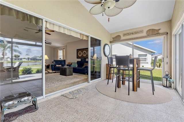 sunroom / solarium featuring a ceiling fan and vaulted ceiling