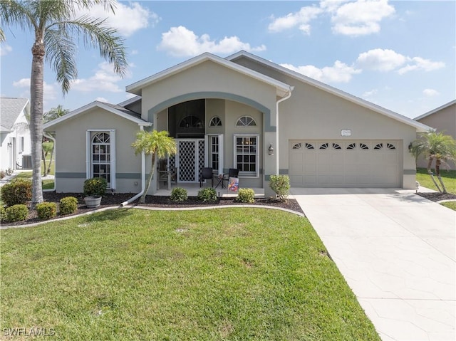 view of front of home with a garage, a front yard, concrete driveway, and stucco siding