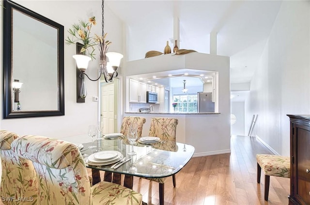 28068 Cavendish Ct Unit 2308, Bonita Springs, FL 34135 - dining area with wood finished floors and a chandelier