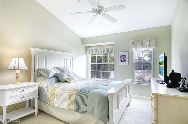 bedroom featuring ceiling fan, baseboards, vaulted ceiling, and light colored carpet