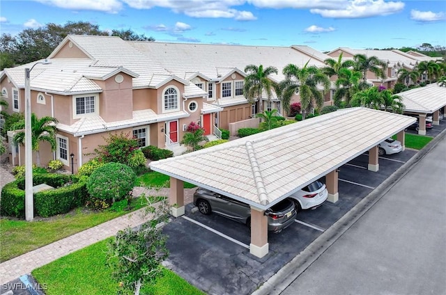 surrounding community featuring uncovered parking and a residential view