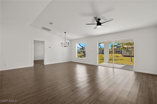 unfurnished living room featuring visible vents, dark wood-type flooring, vaulted ceiling, baseboards, and ceiling fan with notable chandelier