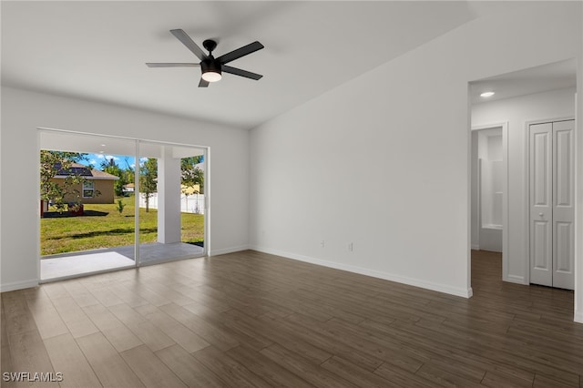 empty room with baseboards, a ceiling fan, and wood finished floors