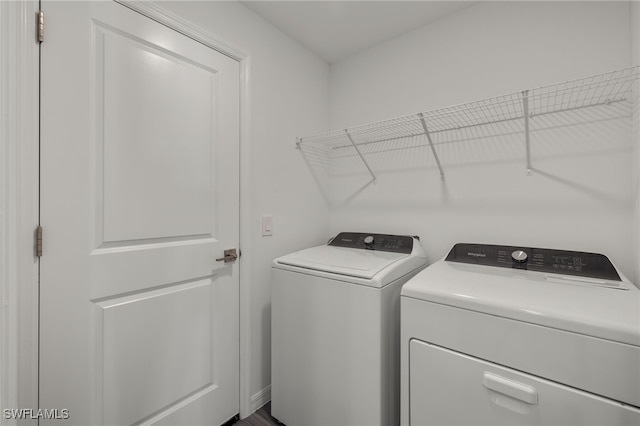 washroom featuring laundry area and washing machine and dryer