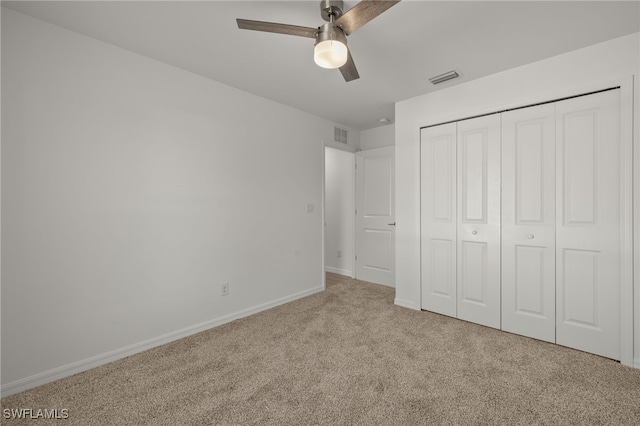 unfurnished bedroom with visible vents, baseboards, a ceiling fan, carpet, and a closet