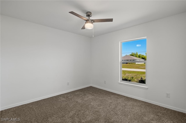 spare room featuring carpet, ceiling fan, and baseboards