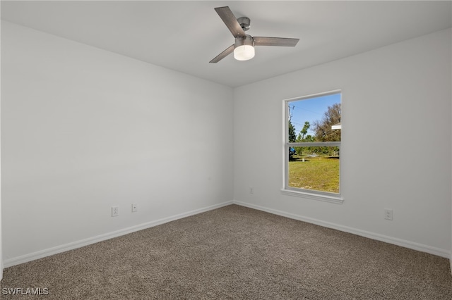 empty room featuring carpet floors, baseboards, and a ceiling fan