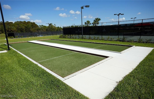 surrounding community featuring fence and a lawn