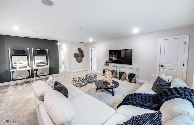 living room featuring recessed lighting, baseboards, and light colored carpet