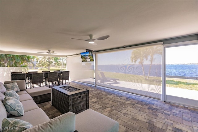 sunroom / solarium featuring a ceiling fan and a healthy amount of sunlight