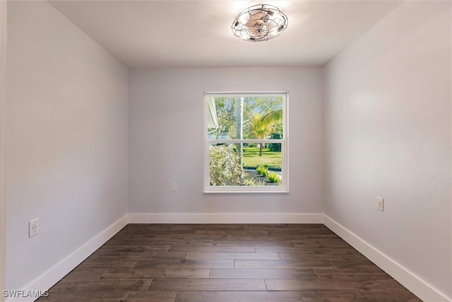 unfurnished room featuring dark wood finished floors and baseboards