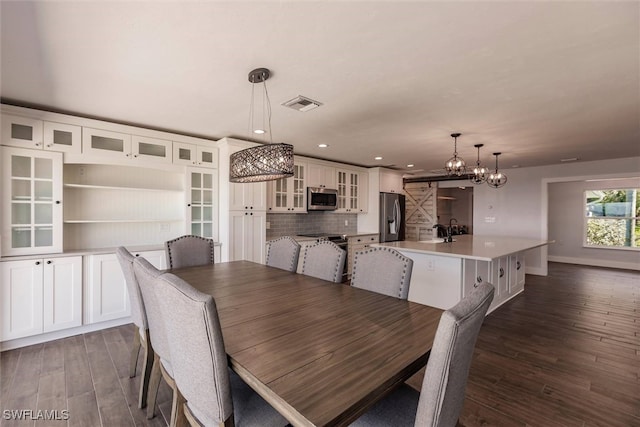 dining room featuring baseboards, visible vents, dark wood-style flooring, and recessed lighting