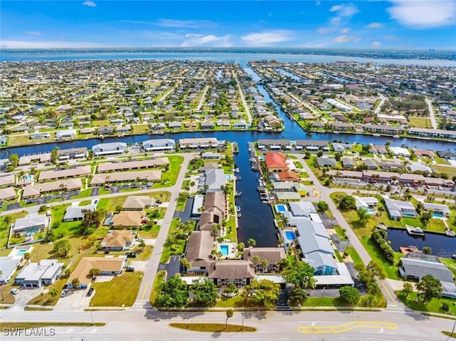 drone / aerial view with a residential view and a water view