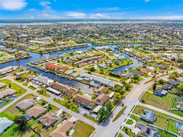 birds eye view of property featuring a water view and a residential view