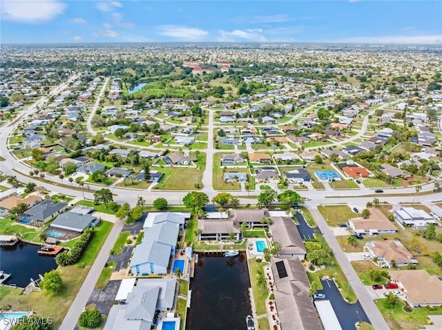 bird's eye view with a water view and a residential view