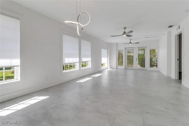 unfurnished room featuring visible vents and a healthy amount of sunlight