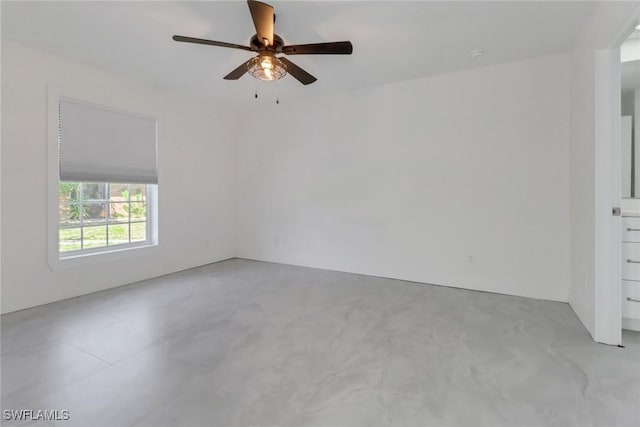 empty room with concrete flooring and ceiling fan