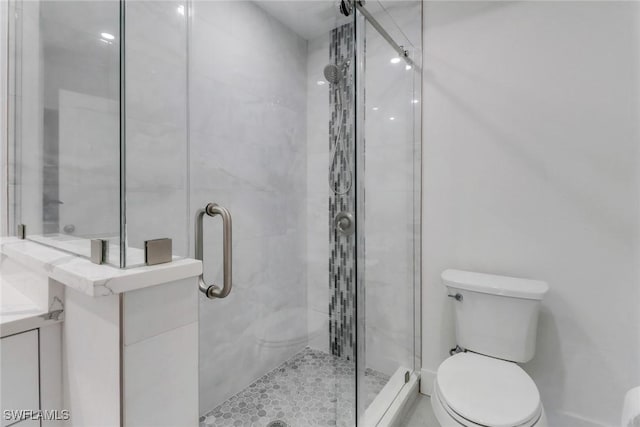 full bath featuring a stall shower and toilet