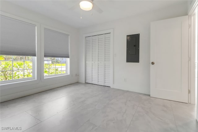 unfurnished bedroom with ceiling fan and electric panel