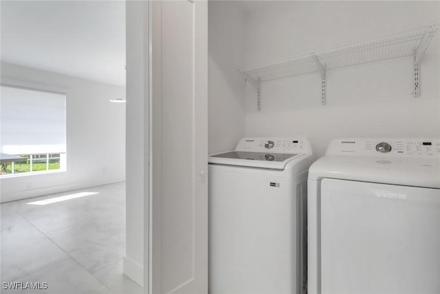 washroom featuring laundry area and washing machine and dryer