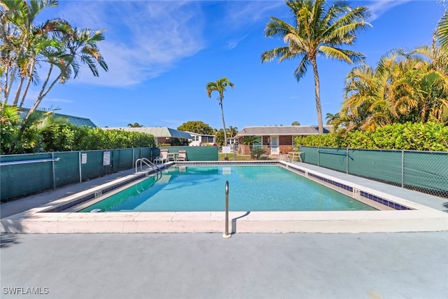 view of swimming pool with fence