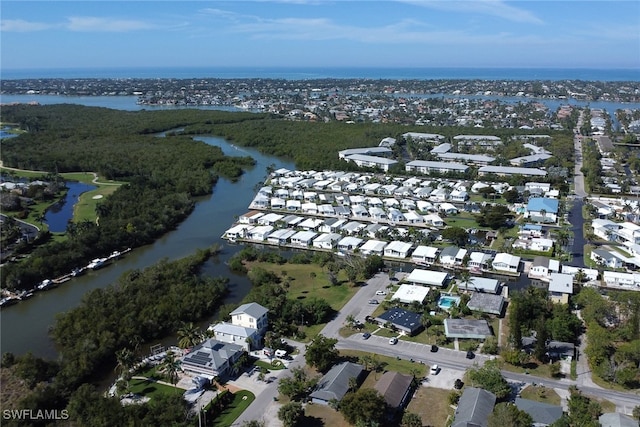 drone / aerial view featuring a water view and a residential view