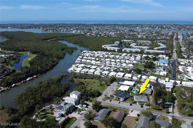 birds eye view of property with a residential view and a water view