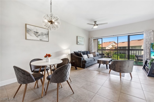 dining area featuring light tile patterned floors, ceiling fan with notable chandelier, and baseboards