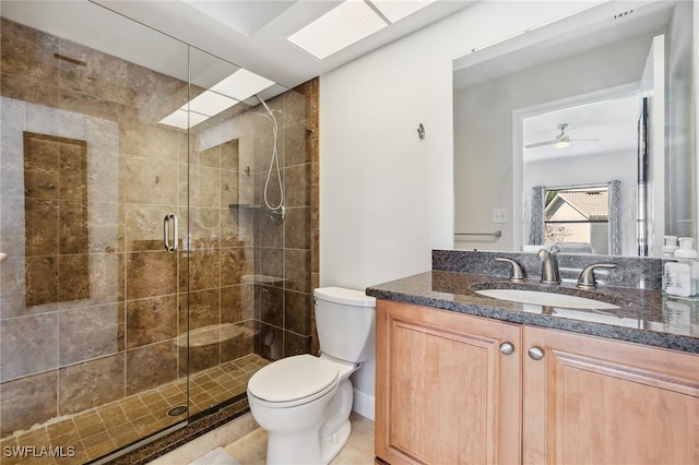 full bath with a stall shower, vanity, and toilet