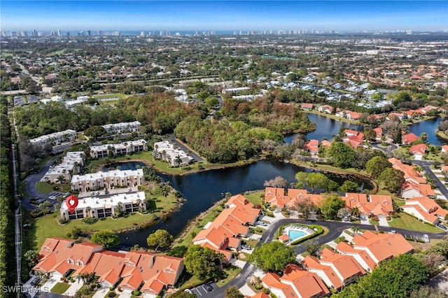 birds eye view of property with a water view and a residential view