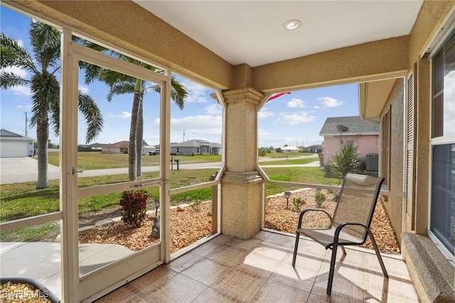 sunroom featuring a residential view