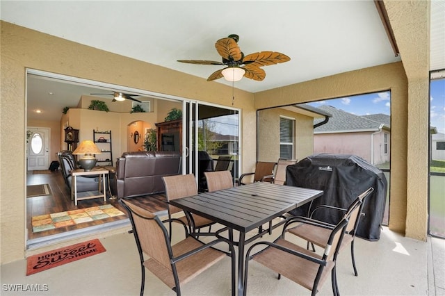 view of patio / terrace with outdoor dining area, a ceiling fan, and area for grilling