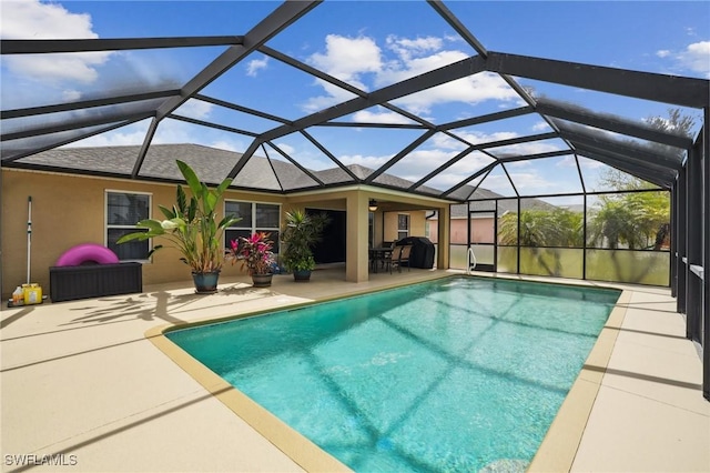 outdoor pool featuring a patio area and a lanai