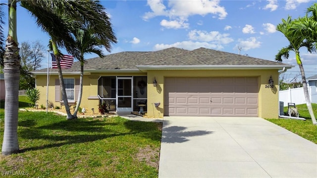 single story home featuring a front lawn, an attached garage, fence, and stucco siding