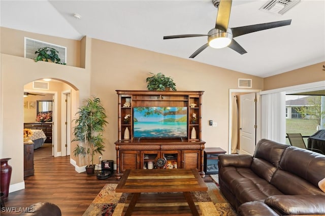 living area with arched walkways, vaulted ceiling, and visible vents